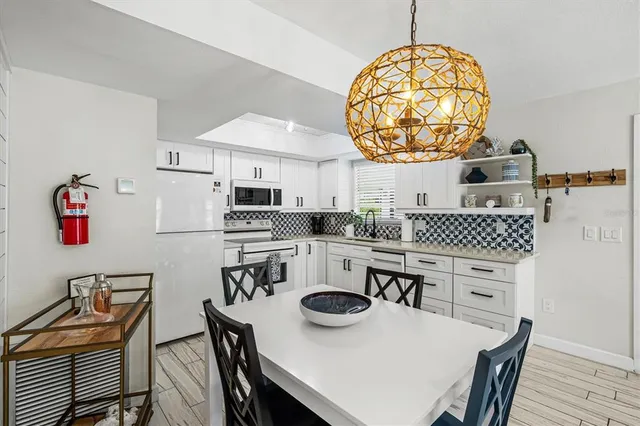 a backyard of a house with barbeque oven table and chairs