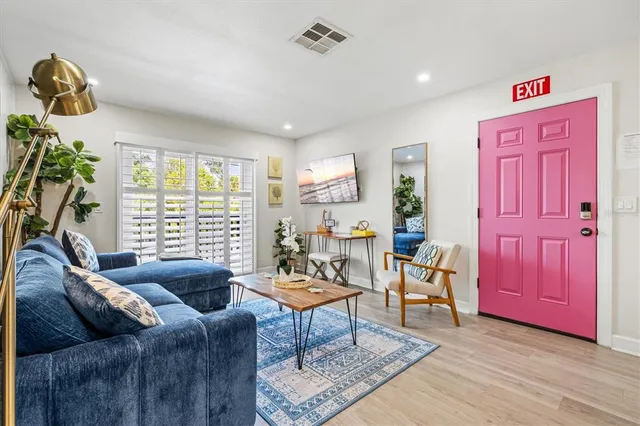 a living room with furniture and a potted plant