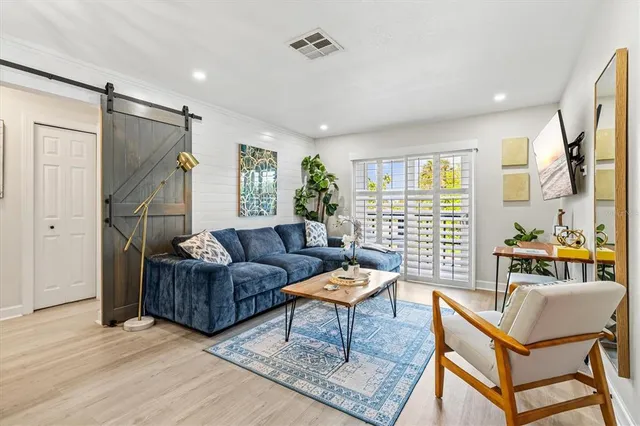 a view of a dining room with furniture a chandelier and wooden floor