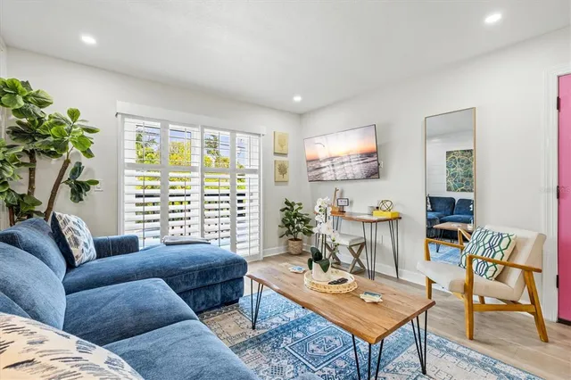 a kitchen with a refrigerator and white cabinets