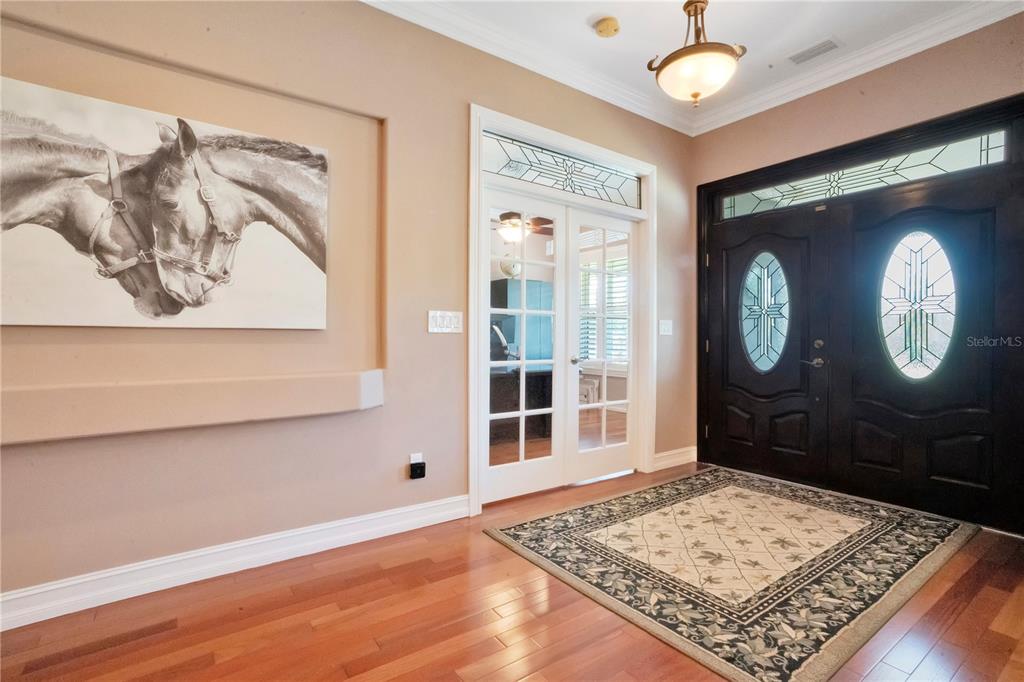 5785 Gilliam Road Orlando, FL 32818 - Photo 17 of 100 a view of a hallway with wooden floor and a window