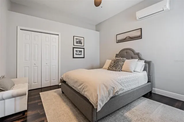 a bedroom with bed and cupboard