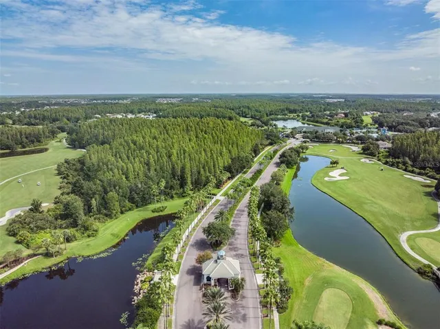 an aerial view of a house with a garden and lake view