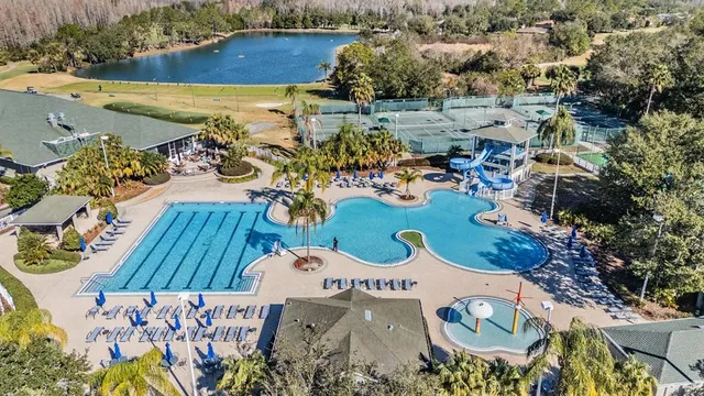 an aerial view of a house yard swimming pool and outdoor seating