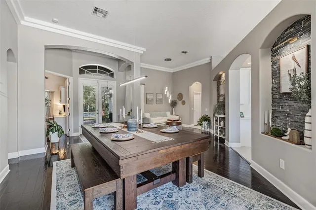 a view of a a dining room with furniture window and wooden floor