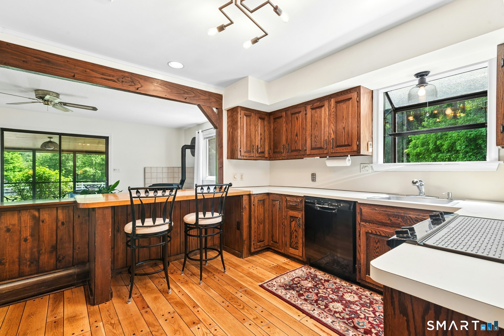 127 Huntingtown Road Newtown, CT 06470 - Photo 11 of 38 a kitchen with a sink cabinets and wooden floor