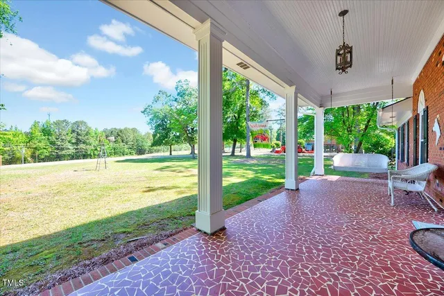 a balcony view with a couch and wooden floor