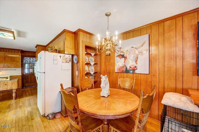a view of a dining room with furniture and chandelier