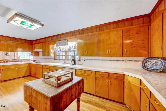 a living room with stainless steel appliances kitchen island granite countertop furniture and a view of kitchen