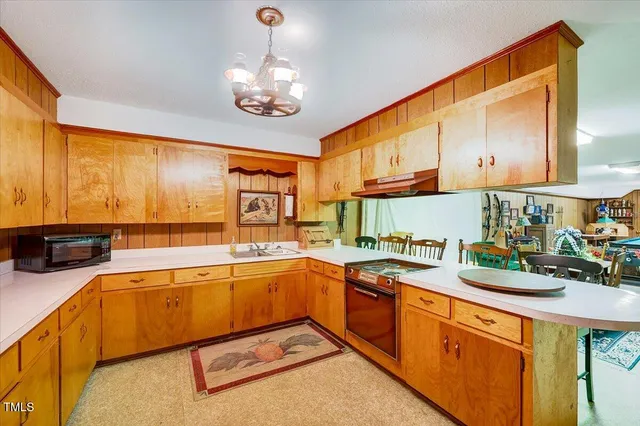 a kitchen with stainless steel appliances granite countertop a refrigerator a stove and a sink