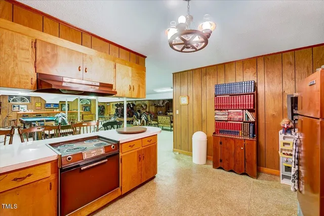 a kitchen with stainless steel appliances a sink stove and cabinets