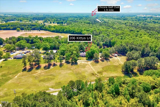 a view of a house with swimming pool and a yard