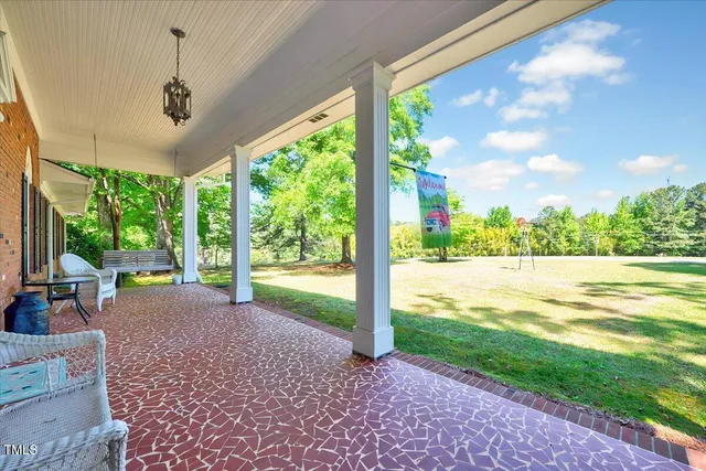a view of a house with a yard and porch