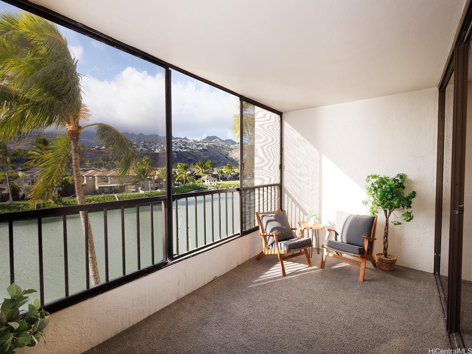 500 Lunalilo Home Road, Unit 13B Honolulu, HI 96825 - Photo 13 of 17 a living room with furniture and a floor to ceiling window