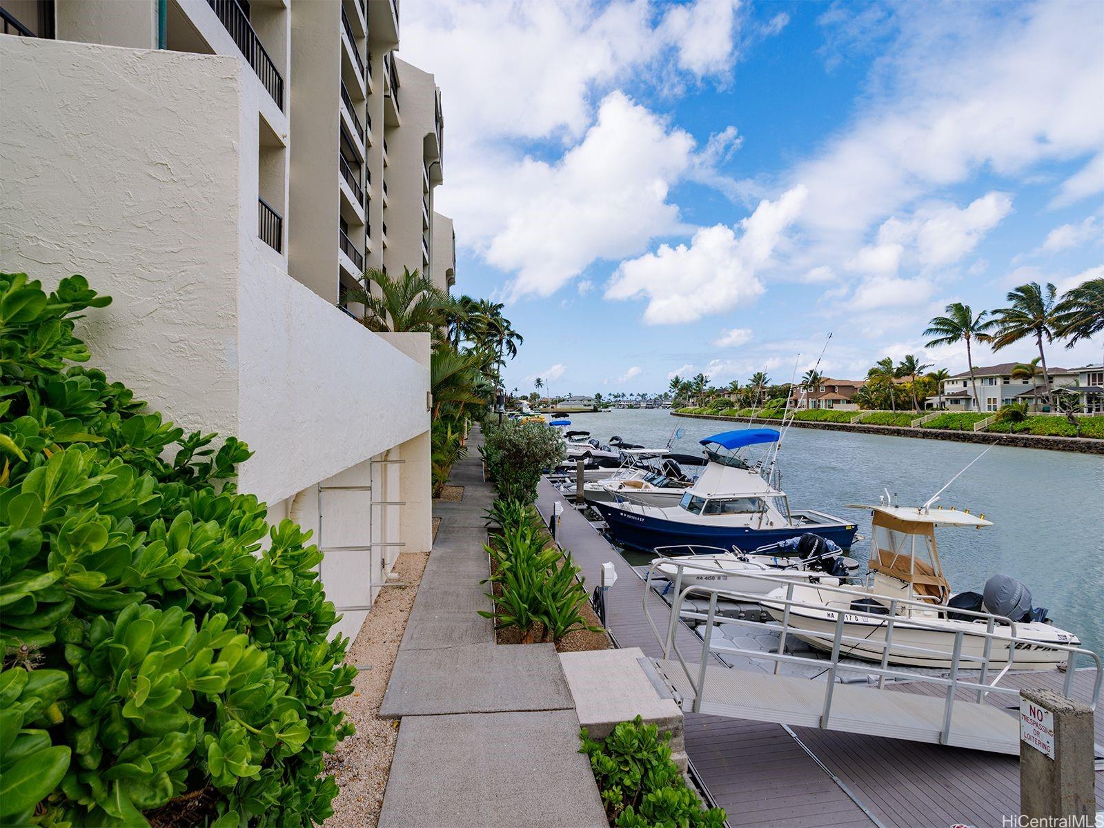 500 Lunalilo Home Road, Unit 13B Honolulu, HI 96825 - Photo 17 of 17 a view of a patio with table and chairs potted plants and a fountain