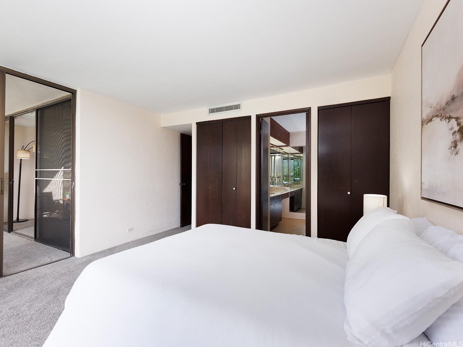 500 Lunalilo Home Road, Unit 13B Honolulu, HI 96825 - Photo 9 of 17 a bedroom with a large bed and a closet