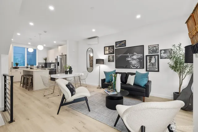 a living room with furniture and a dining table with kitchen view