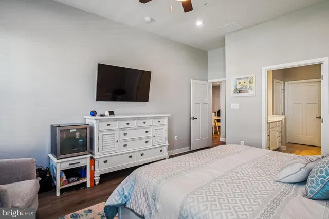 a bedroom with a bed and flat screen tv