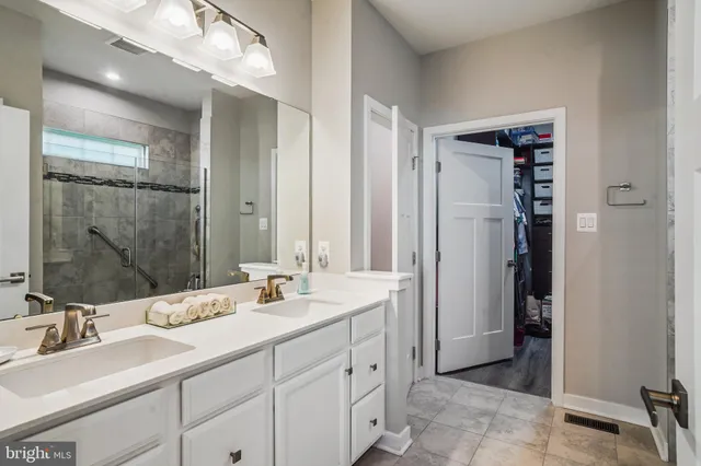 a bathroom with double sink and a mirror