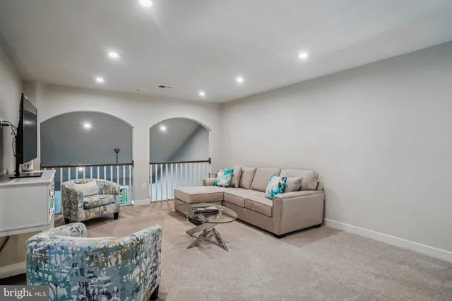 a living room with furniture and a large mirror