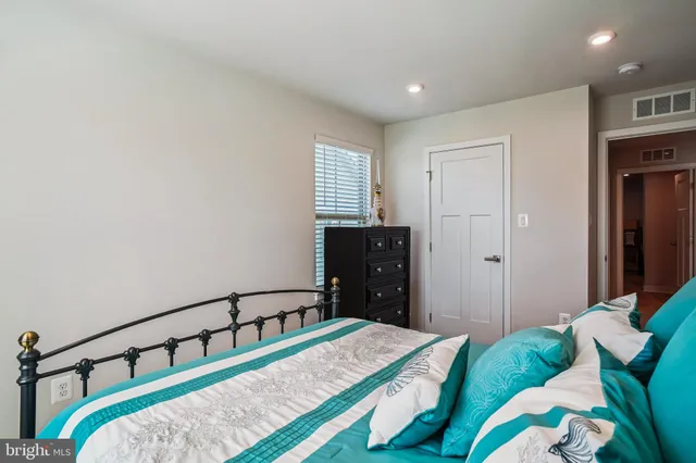 a bedroom with a bed and a dresser