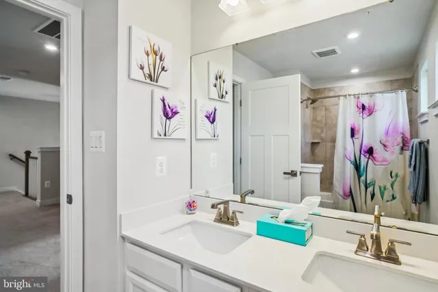 a bathroom with a sink vanity and a mirror