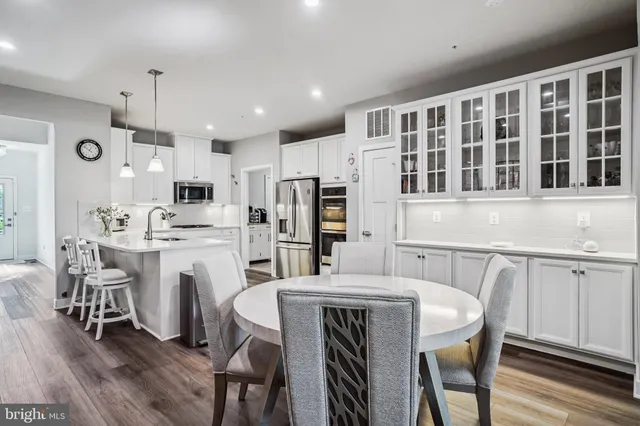 a kitchen with kitchen island wooden cabinets and refrigerator