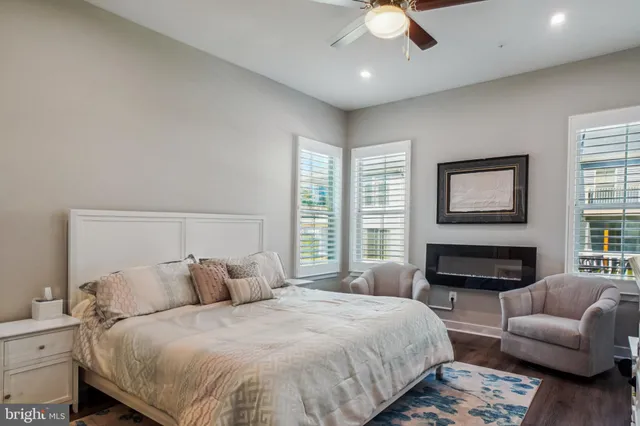 a spacious bedroom with a bed a couch and a fireplace