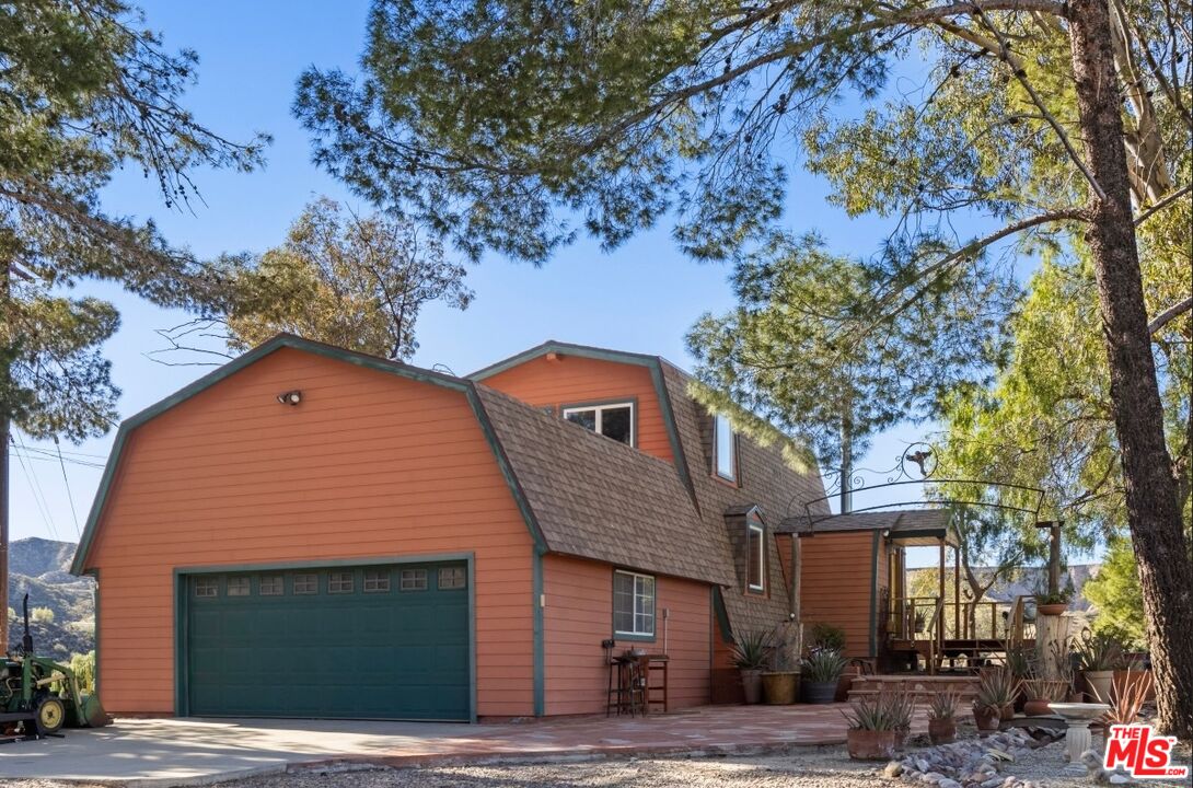 16617 Vasquez Canyon Road Canyon Country, CA 91351 - Photo 1 of 43 a front view of a house with a garden