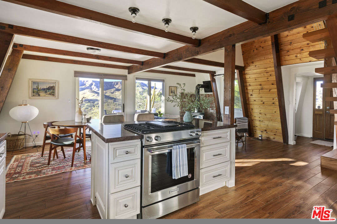 16617 Vasquez Canyon Road Canyon Country, CA 91351 - Photo 12 of 43 a kitchen with a stove and wooden floor