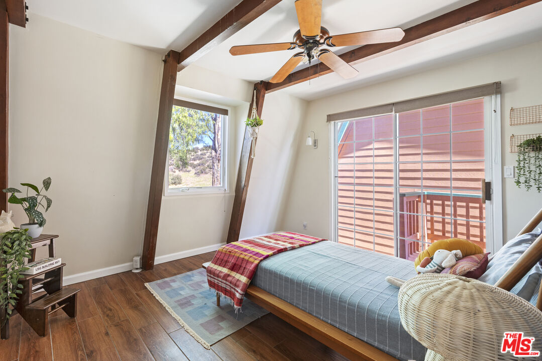 16617 Vasquez Canyon Road Canyon Country, CA 91351 - Photo 25 of 43 a bedroom with a bed and wooden floor