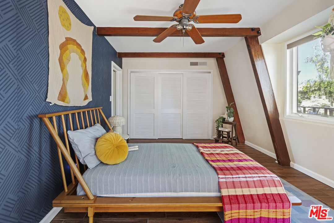 16617 Vasquez Canyon Road Canyon Country, CA 91351 - Photo 26 of 43 a bedroom with a bed and wooden floor