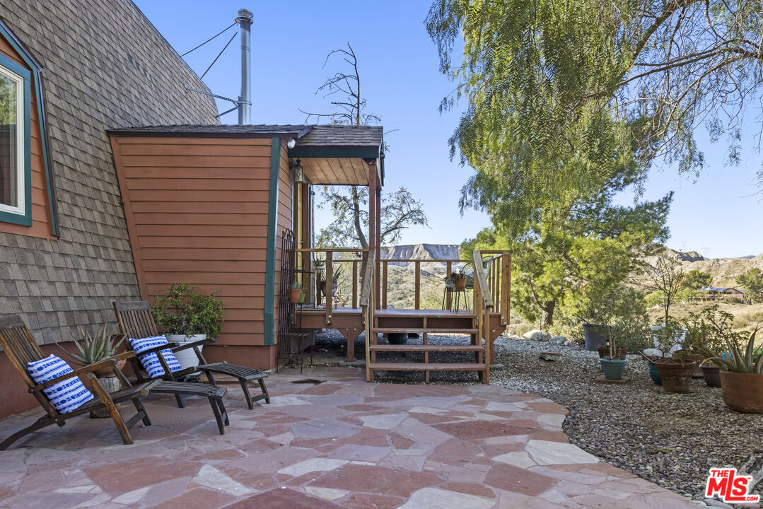 16617 Vasquez Canyon Road Canyon Country, CA 91351 - Photo 29 of 43 a view of patio with a table and chairs and potted plants