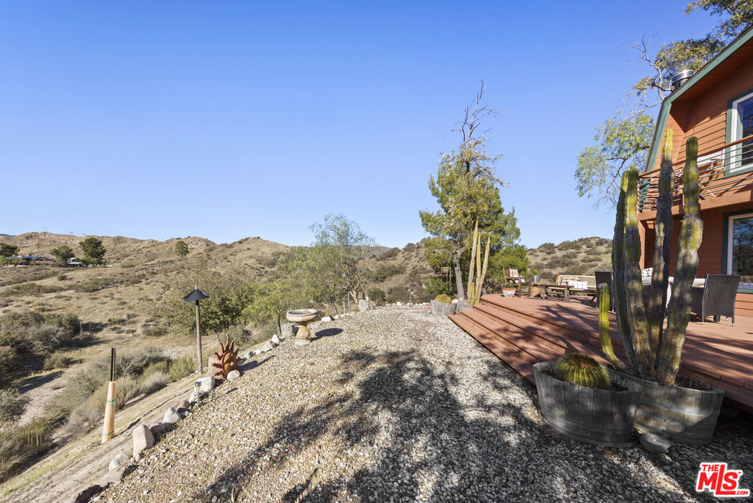 16617 Vasquez Canyon Road Canyon Country, CA 91351 - Photo 36 of 43 a backyard of a house with a mountain
