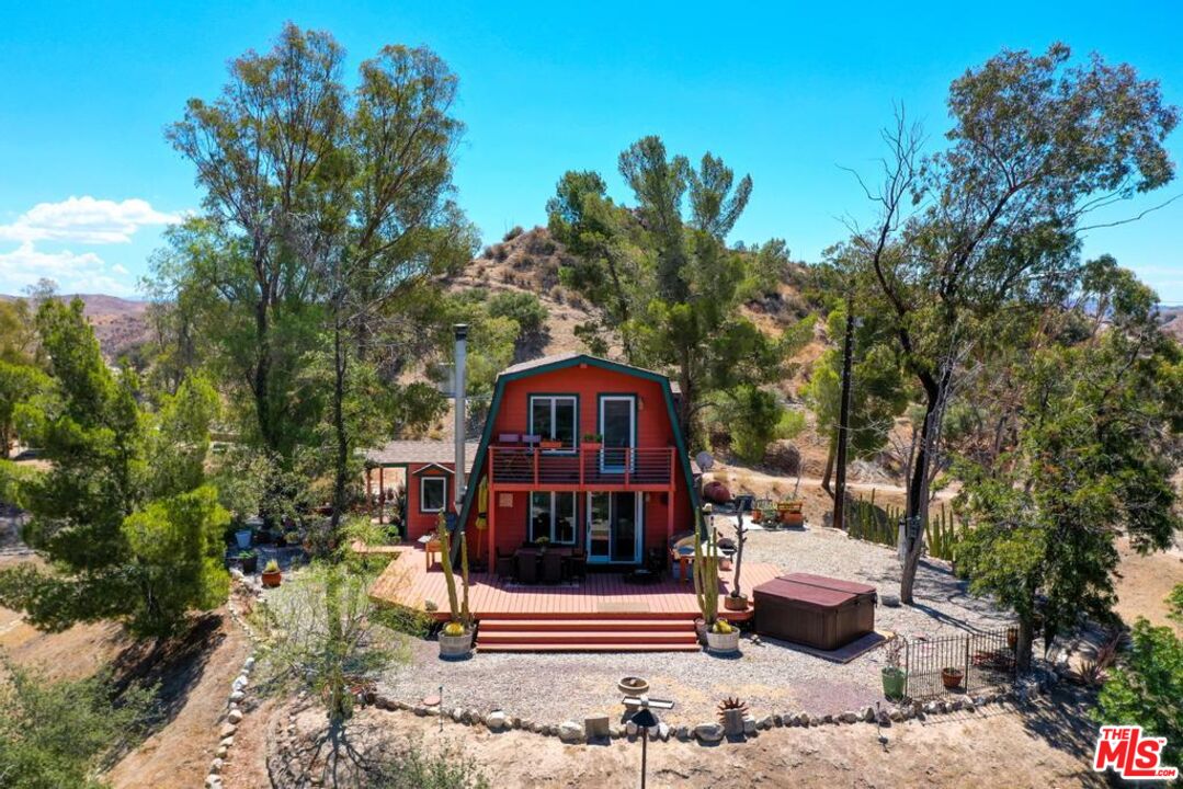 16617 Vasquez Canyon Road Canyon Country, CA 91351 - Photo 39 of 43 a view of a house with a yard chairs and a small yard