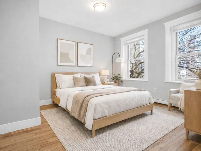 a bedroom with a bed lamp and window