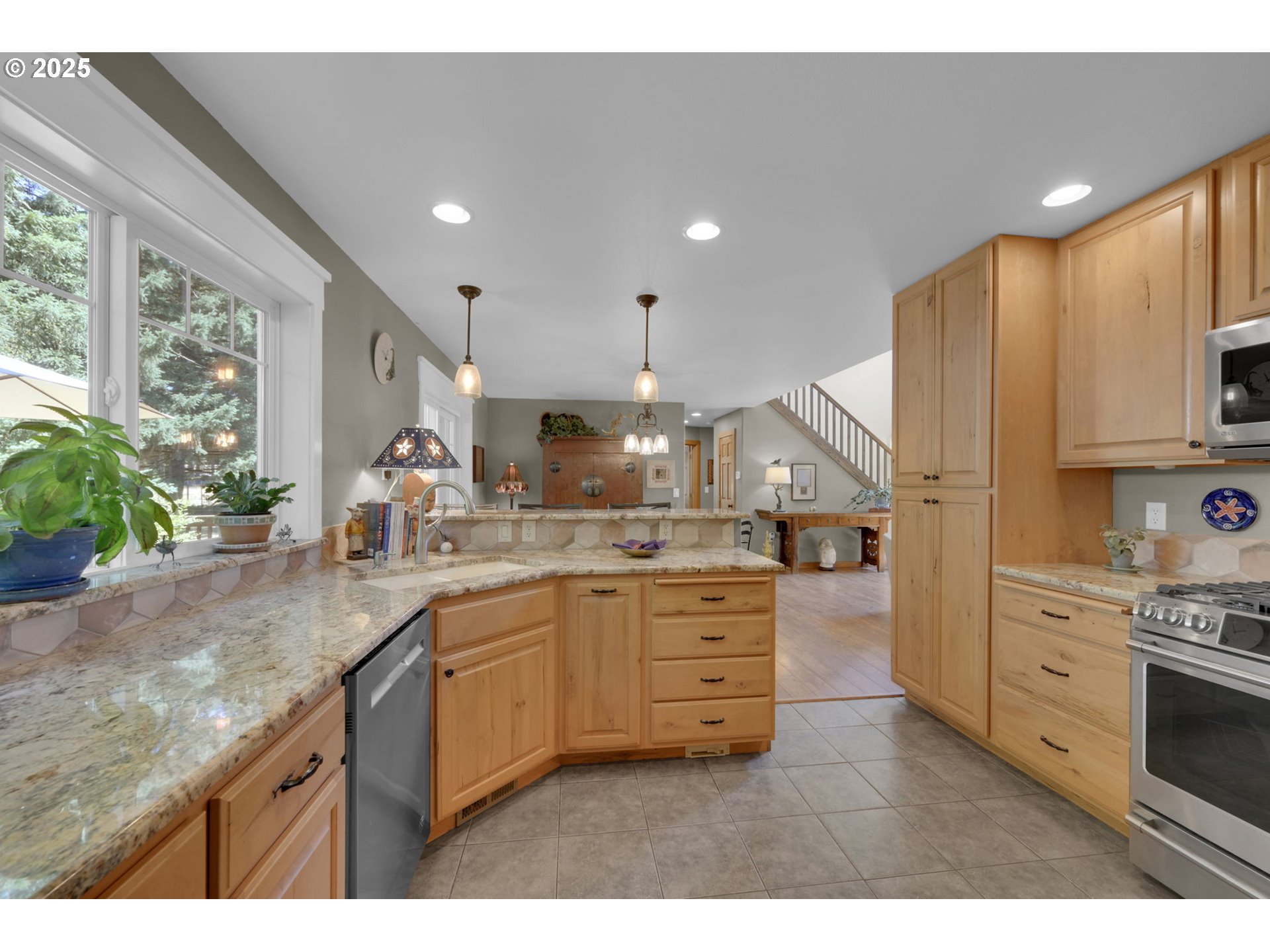 23859 Suttle Road Veneta, OR 97487 - Photo 11 of 46 a kitchen with stainless steel appliances kitchen island granite countertop a sink a stove and a wooden floors