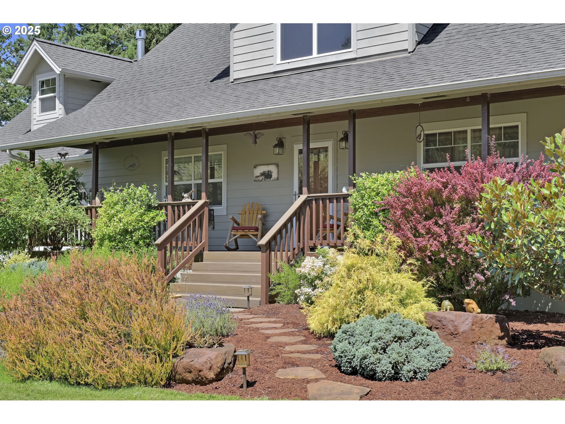 23859 Suttle Road Veneta, OR 97487 - Photo 2 of 46 a view of a house with potted plants and a table