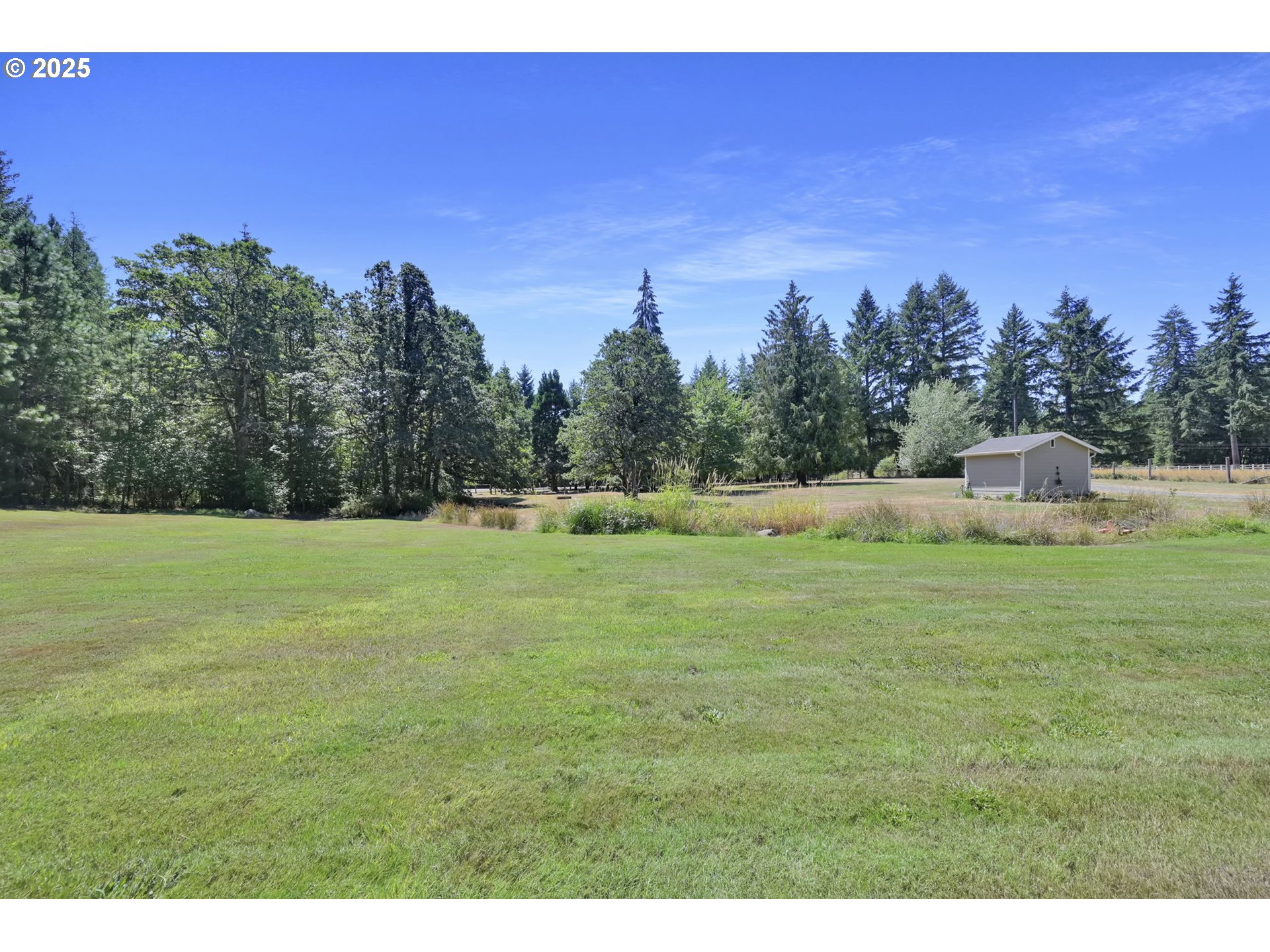 23859 Suttle Road Veneta, OR 97487 - Photo 36 of 46 a backyard of a house with lots of green space and fog