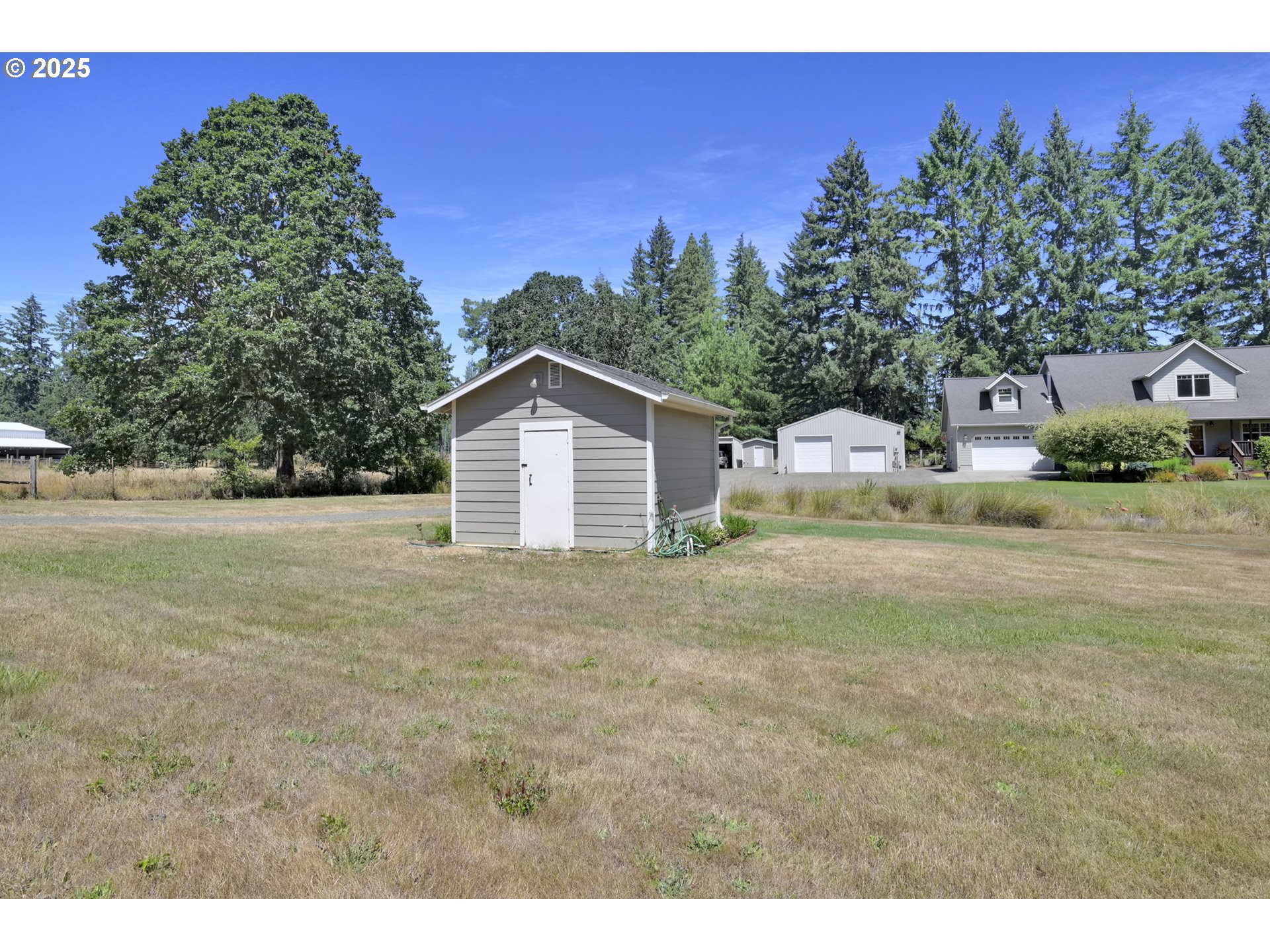 23859 Suttle Road Veneta, OR 97487 - Photo 44 of 46 a view of a house with a yard and garage