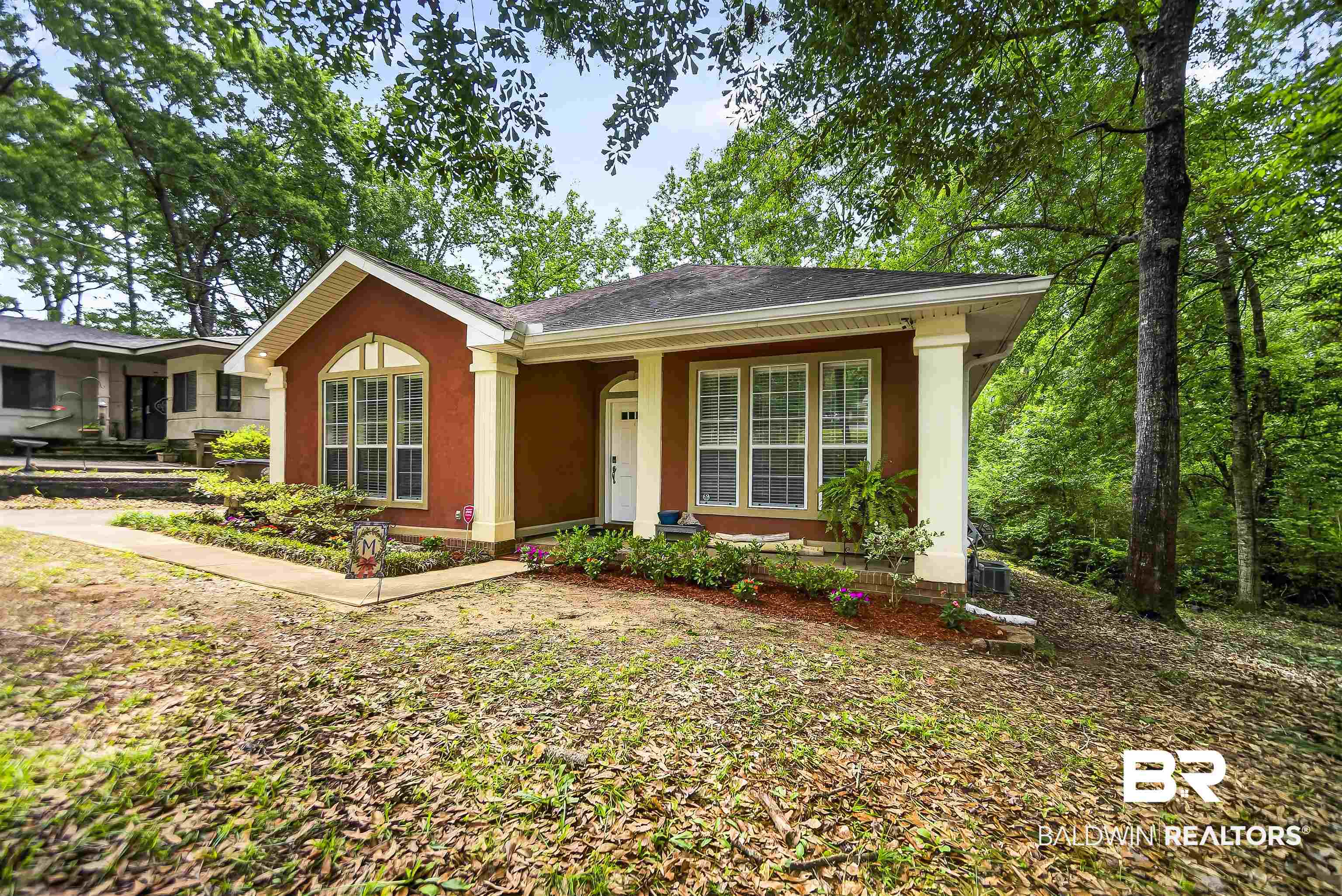 5913 Antoine Road Mobile, AL 36693 - Photo 29 of 33 Single-story residence featuring a terracotta-colored stucco facade with cream trim