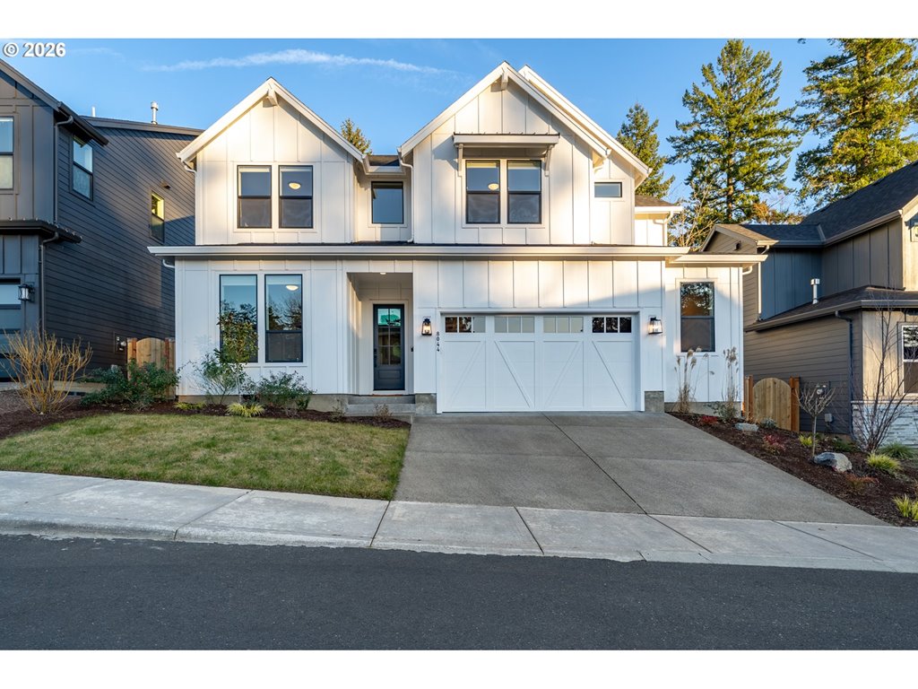 8044 Southwest Knudsen Place Portland, OR 97223 - Photo 1 of 46 a front view of a house with a yard and garage