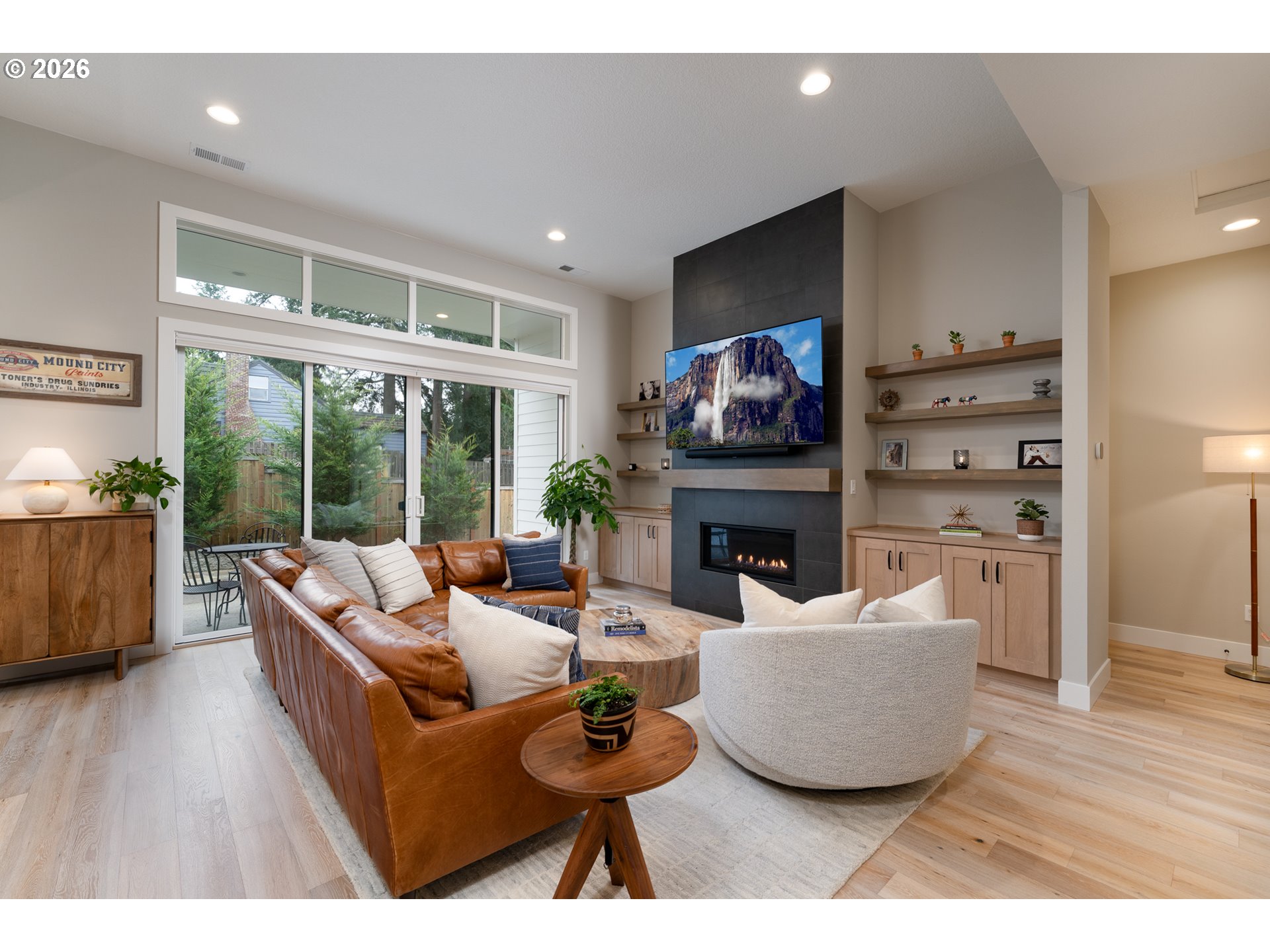8044 Southwest Knudsen Place Portland, OR 97223 - Photo 13 of 46 a living room with furniture a large window and a fireplace