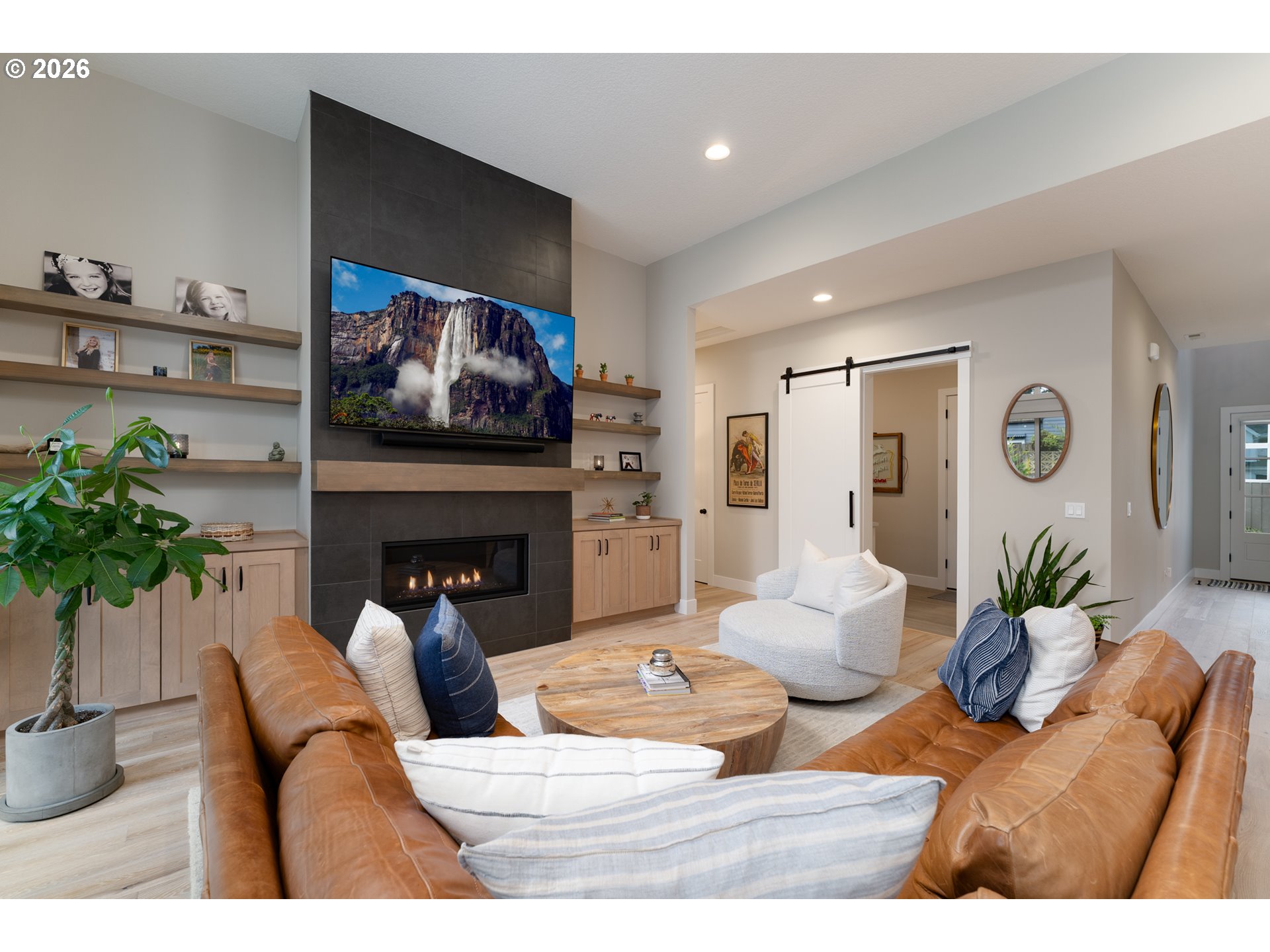 8044 Southwest Knudsen Place Portland, OR 97223 - Photo 14 of 46 a living room with furniture a potted plant and a fireplace
