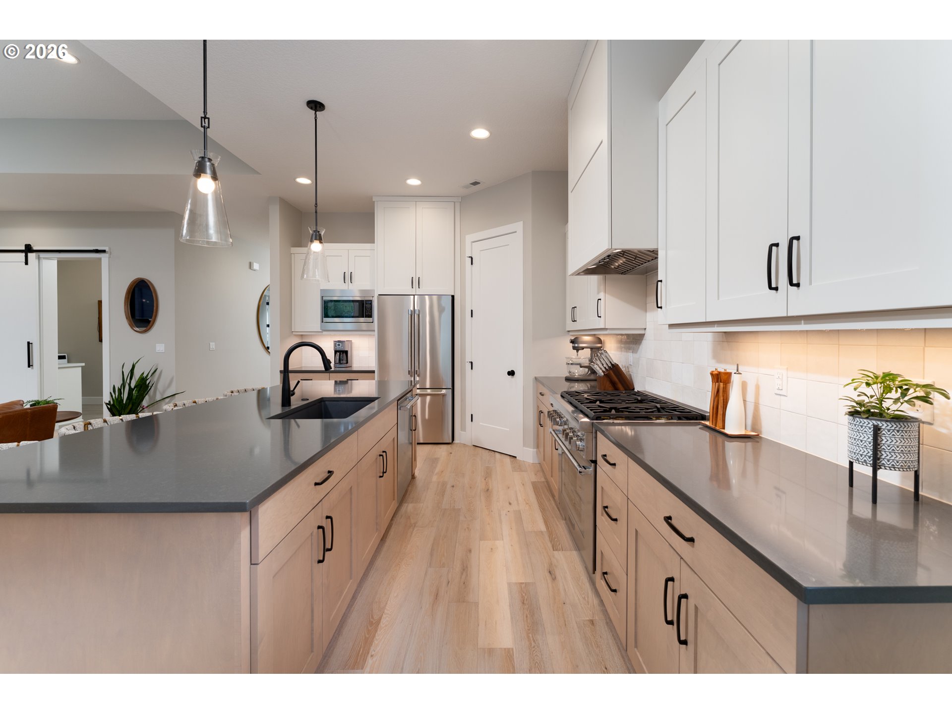 8044 Southwest Knudsen Place Portland, OR 97223 - Photo 19 of 46 a kitchen with stainless steel appliances granite countertop a sink a stove and a refrigerator