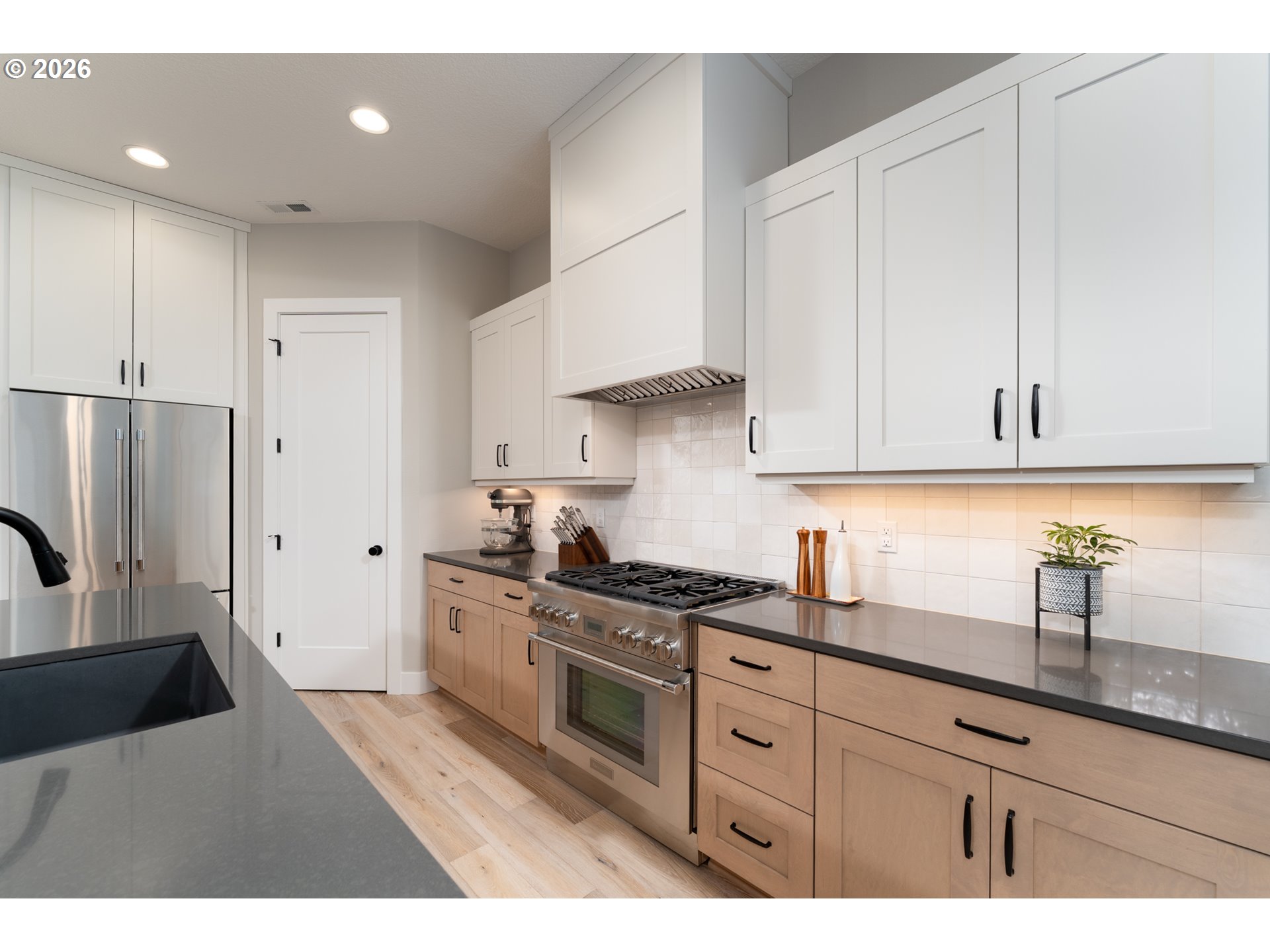 8044 Southwest Knudsen Place Portland, OR 97223 - Photo 20 of 46 a kitchen with granite countertop white cabinets and stainless steel appliances
