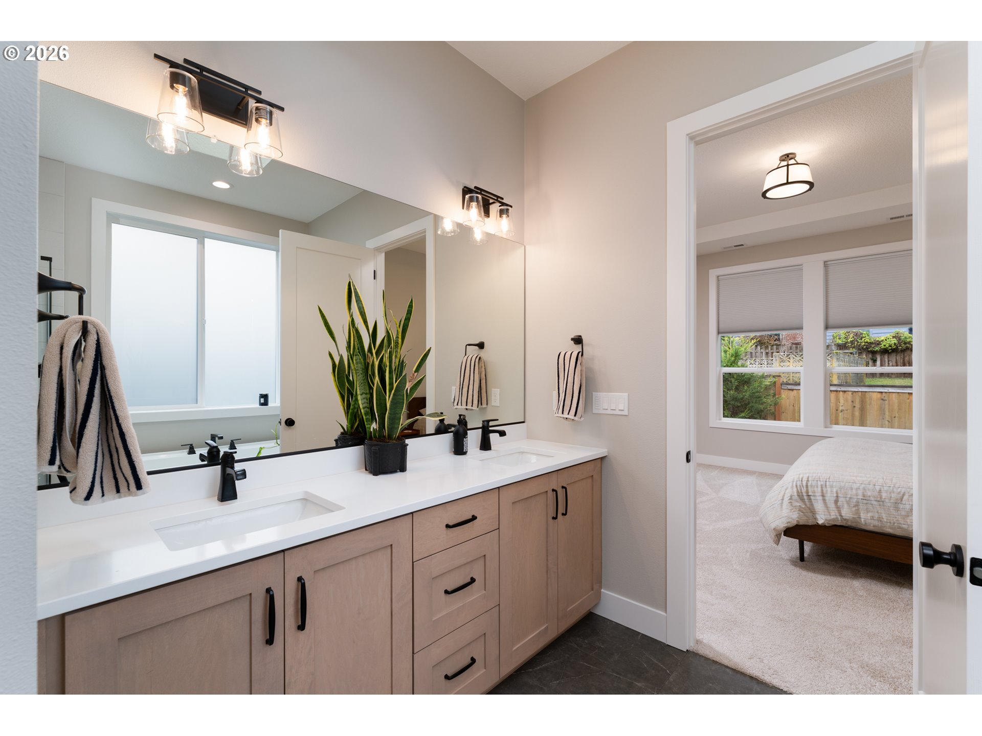 8044 Southwest Knudsen Place Portland, OR 97223 - Photo 29 of 46 a en suite bathroom with a double vanity sink and a mirror