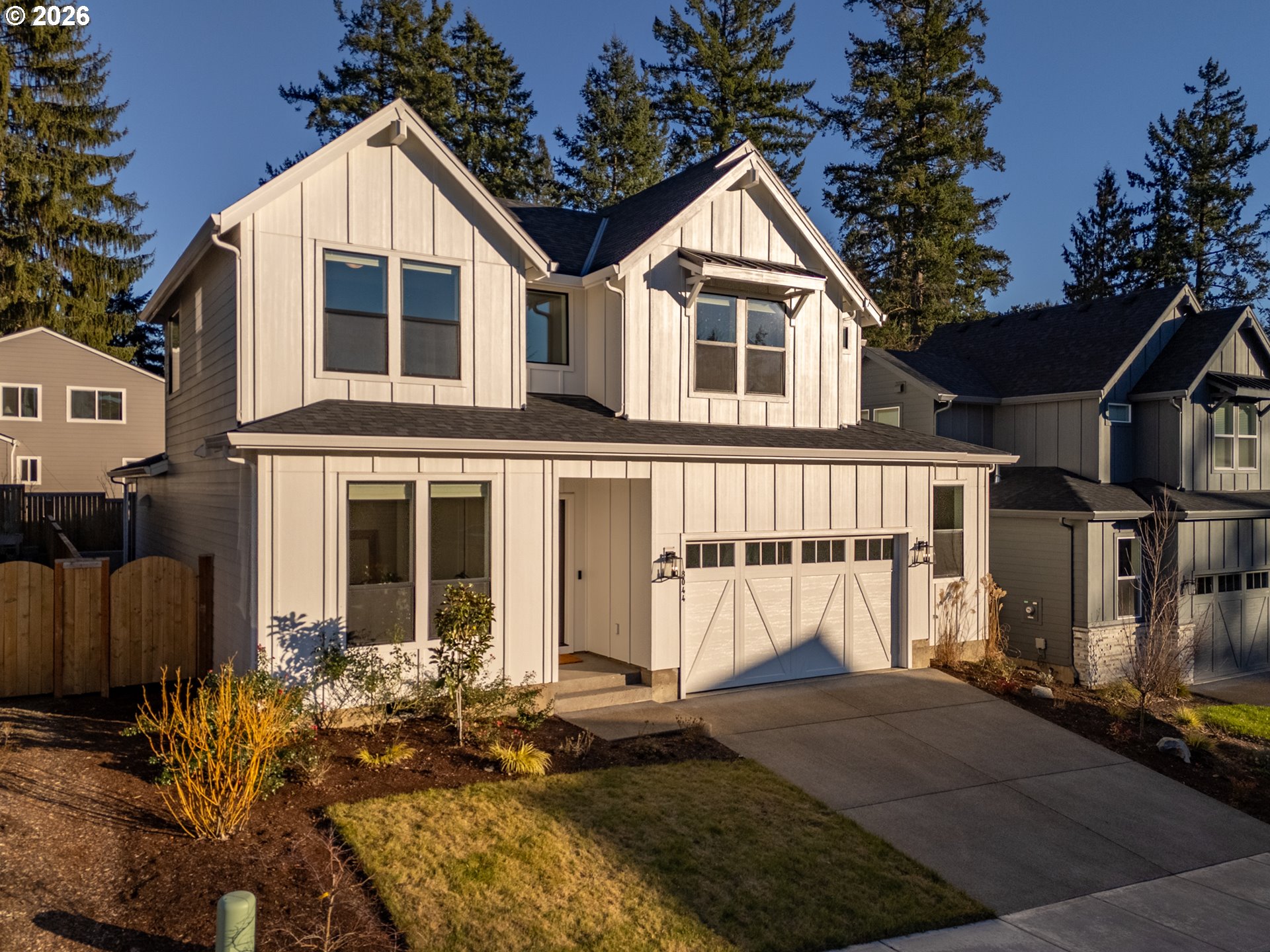 8044 Southwest Knudsen Place Portland, OR 97223 - Photo 3 of 46 a view of a white house with large windows next to a yard