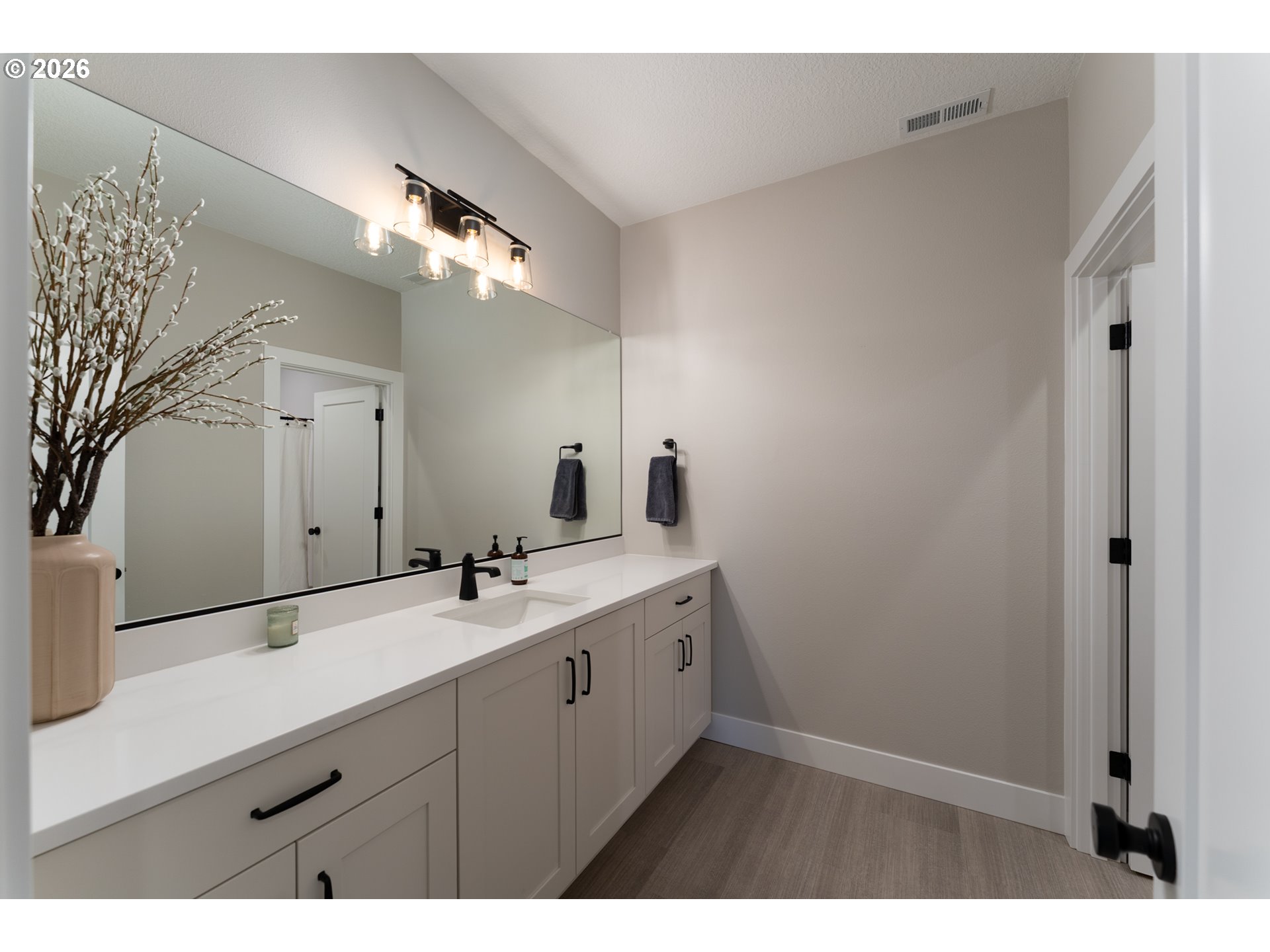 8044 Southwest Knudsen Place Portland, OR 97223 - Photo 37 of 46 a bathroom with a double vanity sink and a mirror