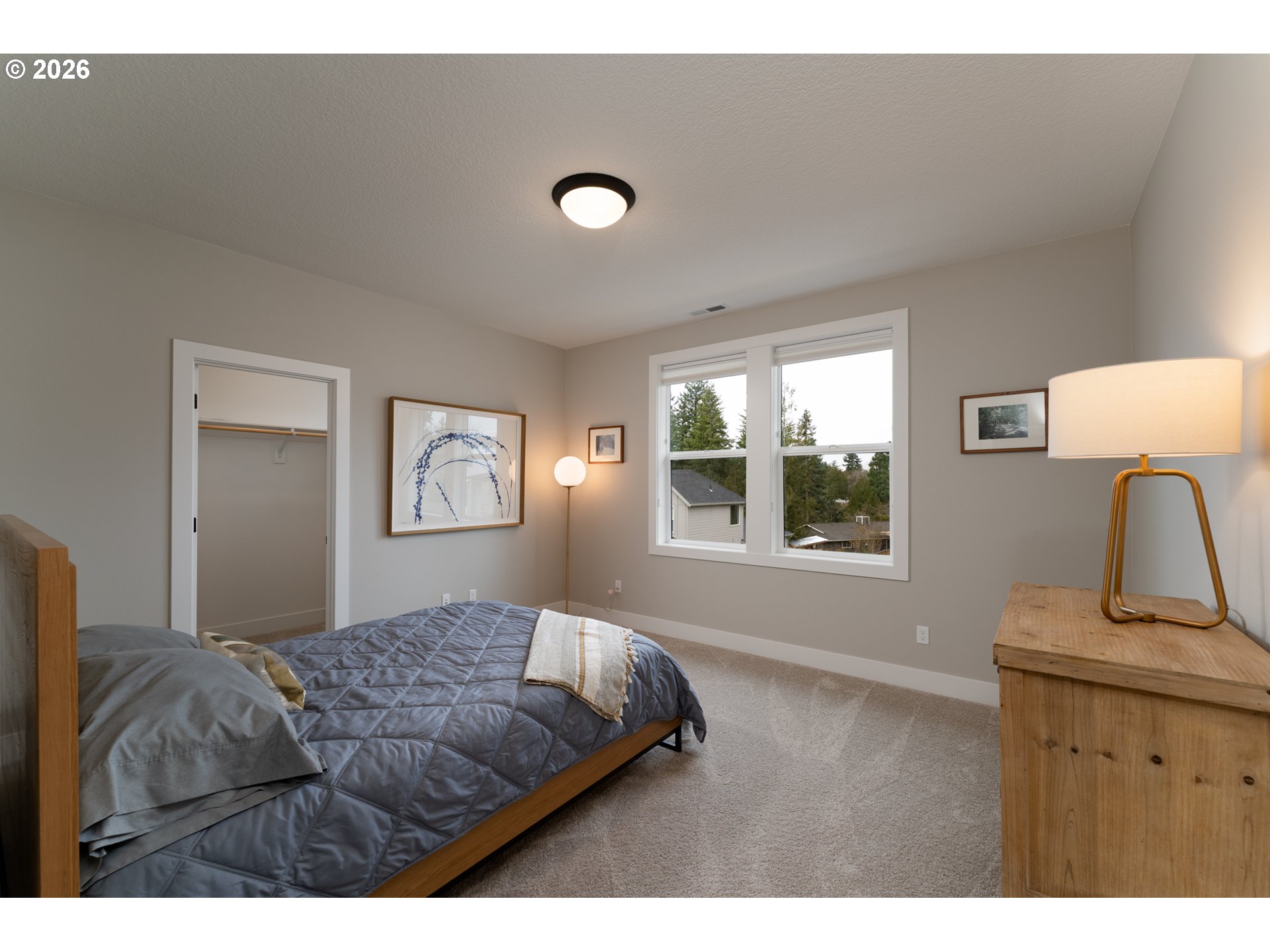 8044 Southwest Knudsen Place Portland, OR 97223 - Photo 39 of 46 a bedroom with a bed window and dresser
